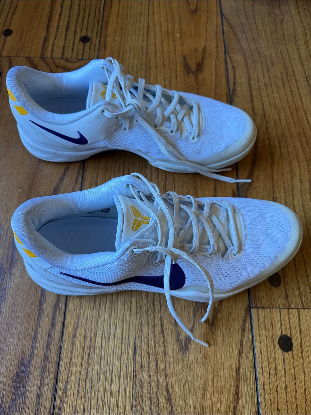 Nike Men’s White Athletic Basketball Shoes with Purple Swoosh and Yellow Accents